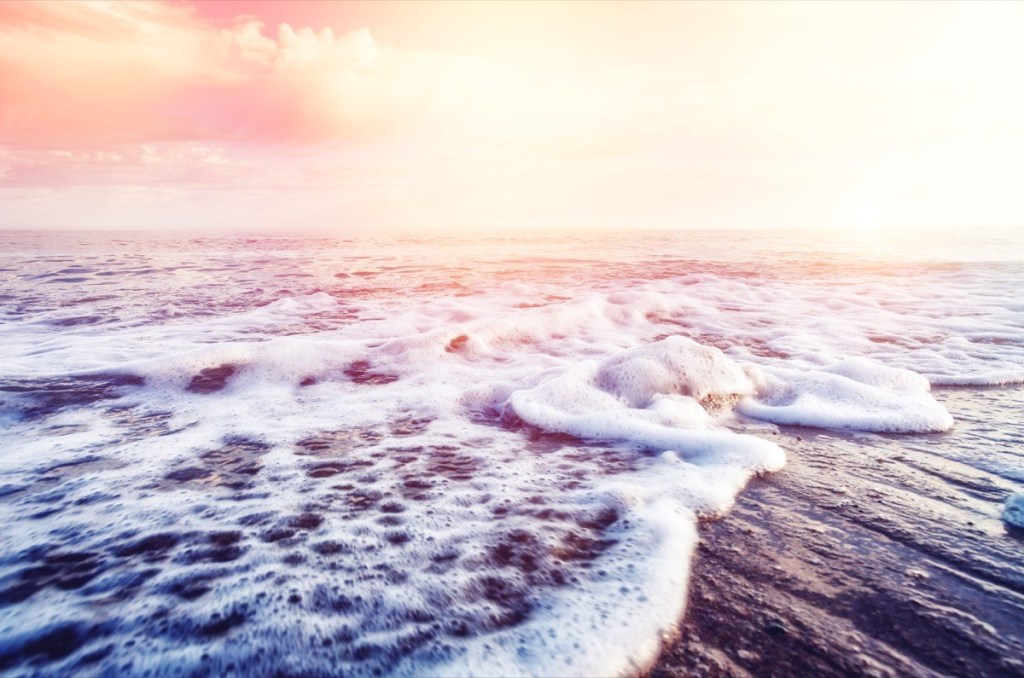 ocean waves on beach at sunrise - why is the ocean salty